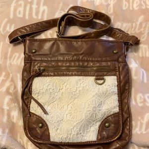 Faux leather cross body with lace pocket.